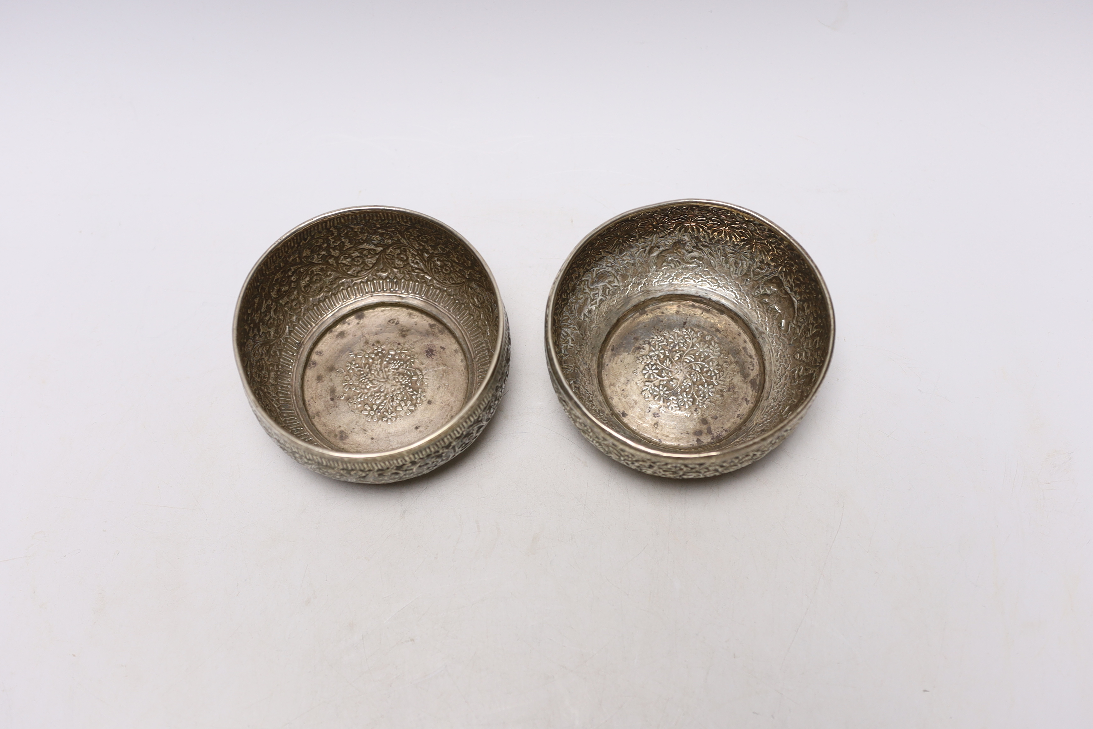 A pair of Indian embossed white metal finger bowls, 10cm, 7.5oz.